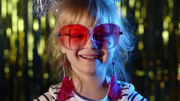 Portrait of Trendy Stylish Girl Looking at Camera Smiling Child Kid in Neon Light at Disco Club