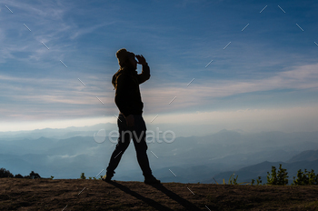 silhouette of a man who looking over the mountains landscape / Photodune, Misc