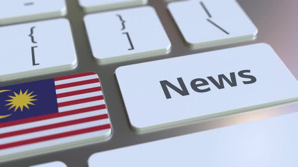 News Text and Flag of Malaysia on the Keys of a Keyboard