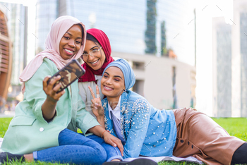Beautiful muslim girl wearing hijab bonding outdoors / Photodune, Misc