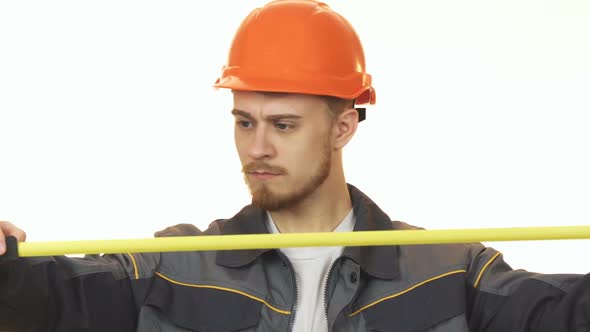 Young Male Engineer Making Measurements Isolated 