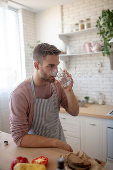 A young man drinking water from a glass / Photodune, Misc