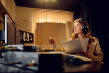 Female engineer in headphones, recording studio / Photodune, Misc