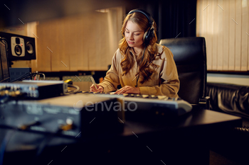 Female engineer in headphones, recording studio / Photodune, Misc