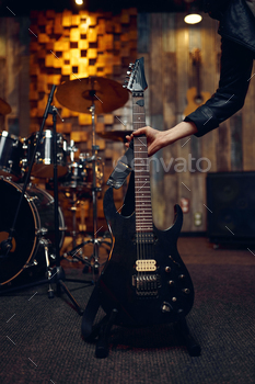 Musician takes electric guitar, music performing / Photodune, Misc