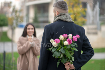 Selective focus of roses hidden behind the back / Photodune, Misc