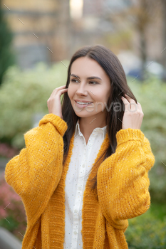 Nice dark haired woman fixing her hair / Photodune, Misc