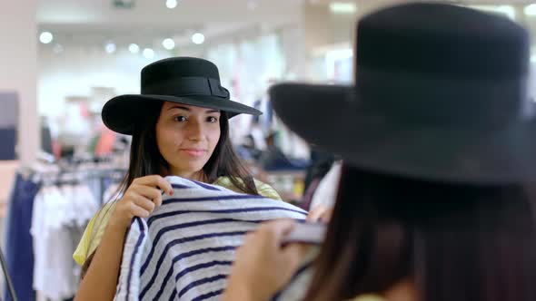 Woman in Hat Trying on Scarves