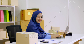 Beautiful muslim female merchandiser doing online marketing at the office. / Photodune, Misc