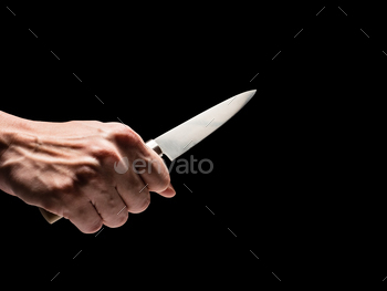 Male hand holding knife on black background. / Photodune, Misc