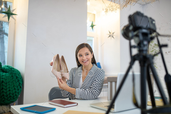 Young brunette woman presenting very beautiful shoes / Photodune, Misc