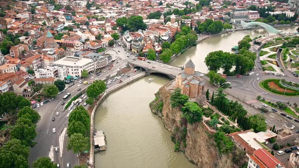 Aerial drone view of Tbilisi, Georgia at cloudy weather. Metekhi Church, water channel, multiple bui
