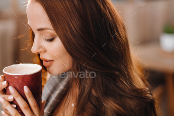 a girl drinks coffee in a coffee shop, beautiful hair of a girl / Photodune, Misc