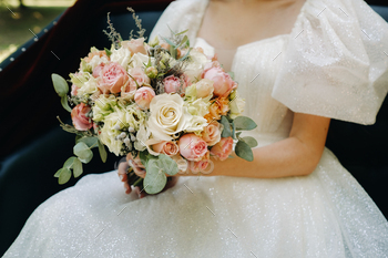 a beautiful wedding bouquet with roses in the hands of the bride / Photodune, Misc