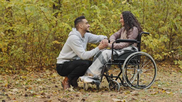 Young Happy Hispanic Couple in Love Having Cute Conversation Talking Caring Boyfriend Visits Sick