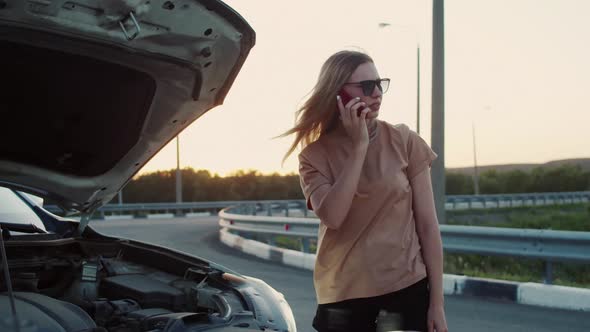 A Frustrated Attractive Business Woman on the Side of the Road Tries To Get Help with Her Broken