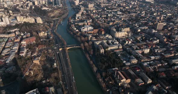 Flying over Shota Rustaveli street in the center of city. Morning aerial cityscape of Tbilisi