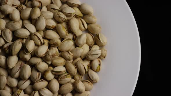 Cinematic, rotating shot of pistachios on a white surface - PISTACHIOS 026