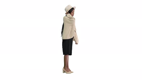 Fashionable African American Woman Posing in Knitwear and White Hat on White Background