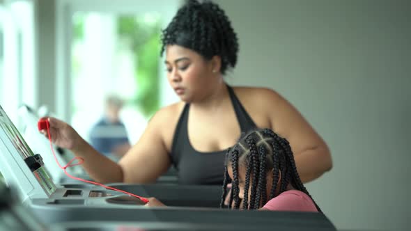 Fitness Woman mon and kid Training Cardio Exercise on Running Machine in Gym Club