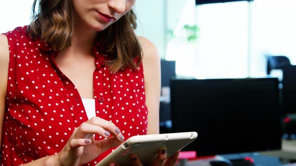 Executive using digital tablet in office