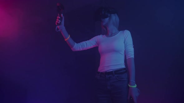 Young Blond Hair Girl Wearing Virtual Reality Headset Holding Joystick Controllers Playing Game