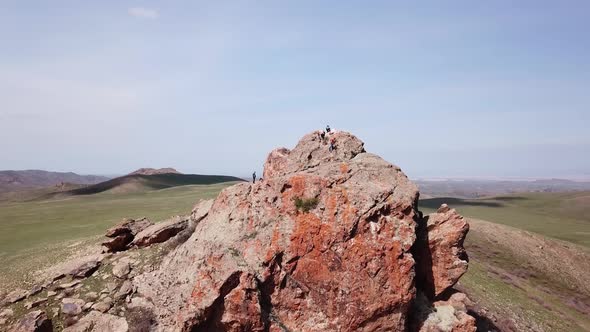 A Huge Rock on the Edge of a Green Hill