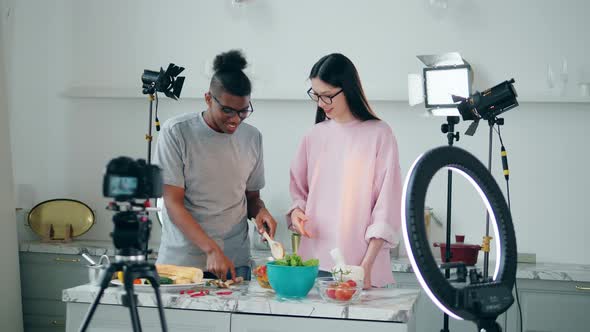 Africanamerican Man and a Woman are Cooking for a Videoshoot