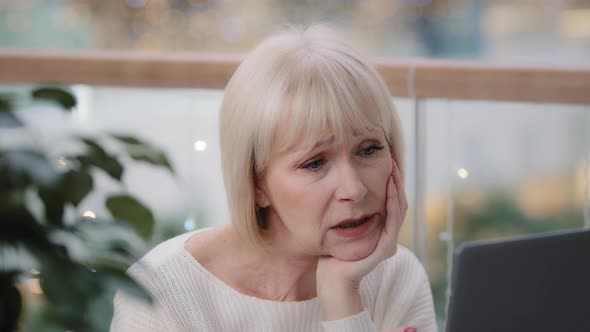 Sad Frustrated Mature Businesswoman Looking Sadly at Laptop Screen Loss of Important Document