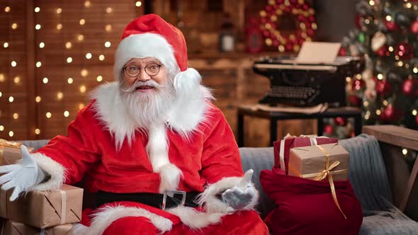 Friendly Elderly Man in Santa Claus Costume Congratulating Merry Christmas