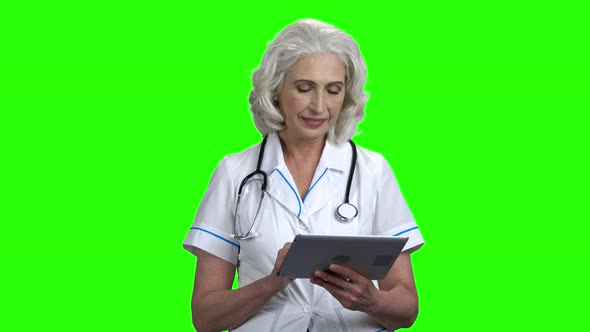 Mature Female Doctor Using Digital Tablet