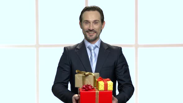 Young Elegant Man Holding Gift Boxes