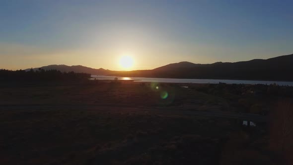 Drone shoots sunset near Big Bear Solar observatory, aerial view of Big Bear Lake, California, USA