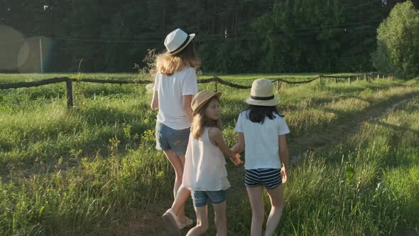 Children Walking Back Along Country Road Turn Their Faces To Look Surprised