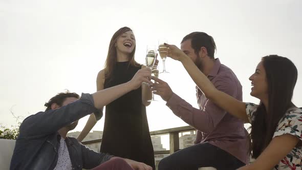Group of friends clinking champagne glasses outdoors