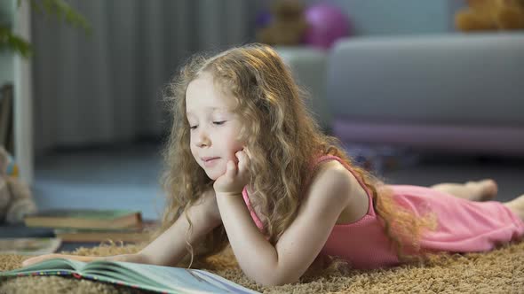 Smart Little Girl Reading Favorite Book at Home on Her Own, Happy Childhood