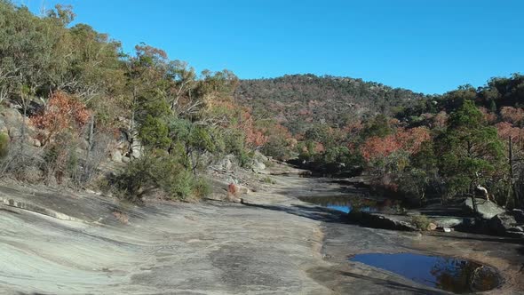 Following a dry creek bed in Australian bush land