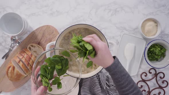 Cooking vegetarian white bean soup in cast iron dutch oven