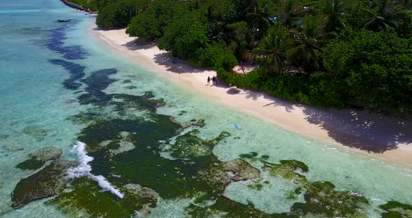 Wide drone travel shot of a summer white paradise sand beach and aqua blue water background in best 