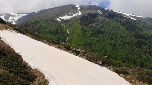 Piece of Snow on the Mountain Slope and Valley