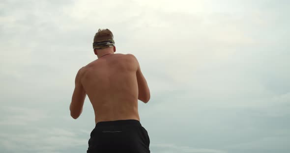 Young Scandinavian Boxer Exercising Outdoors, She Makes Strong Punches