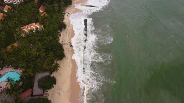 Sand filled geotube aqua bags protecting coastal village town from sea level rise