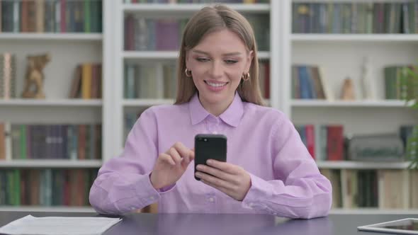 Woman Using Smartphone in Office