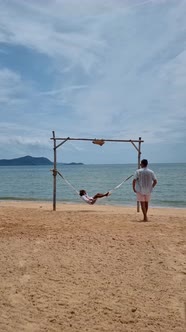 Men and Women Relaxing in Hammock on the Beach in Pattaya Thailand Ban Amphur Beach