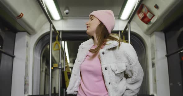 Stylish Millennial Woman Dancing and Singing Song While Going on Public Transport. Attractive Young