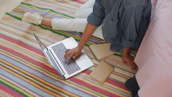 Student Using Computer on Floor