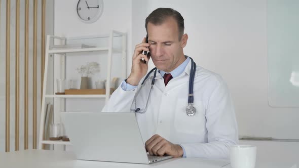 Doctor Attending Phone Call of Patient Discussing Health