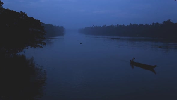 Sunrise in backwaters,fishermen arriving shore,up angle view