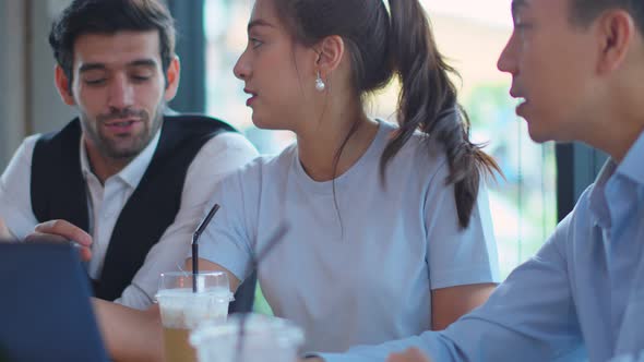 Three asian and caucasian Businesspeople Working discuss finding new strategy solution together