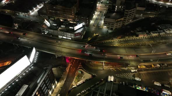 An aerial view above the entrance of the Midtown Tunnel in New York at night. The drone camera tilte